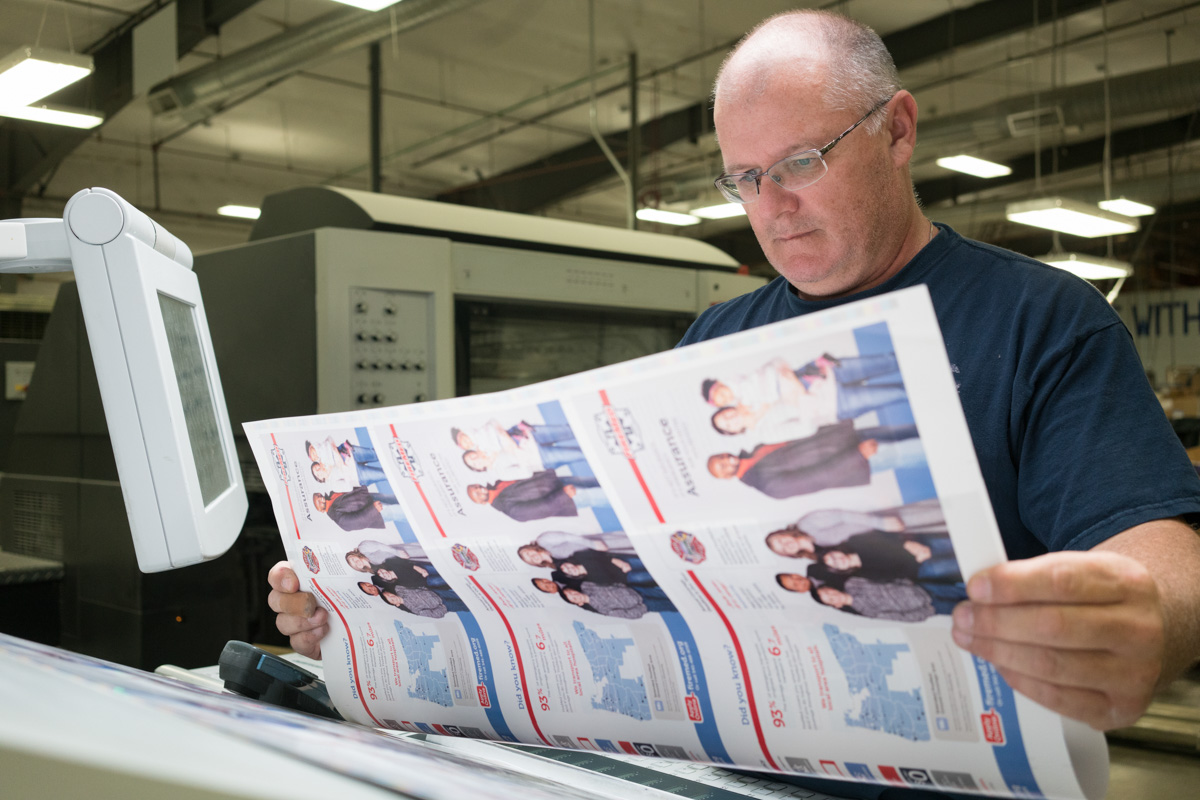 Image of pressman evaluating print color