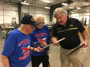 Photo In Our Community - Doug Koke showing off print samples to visiting veterans.