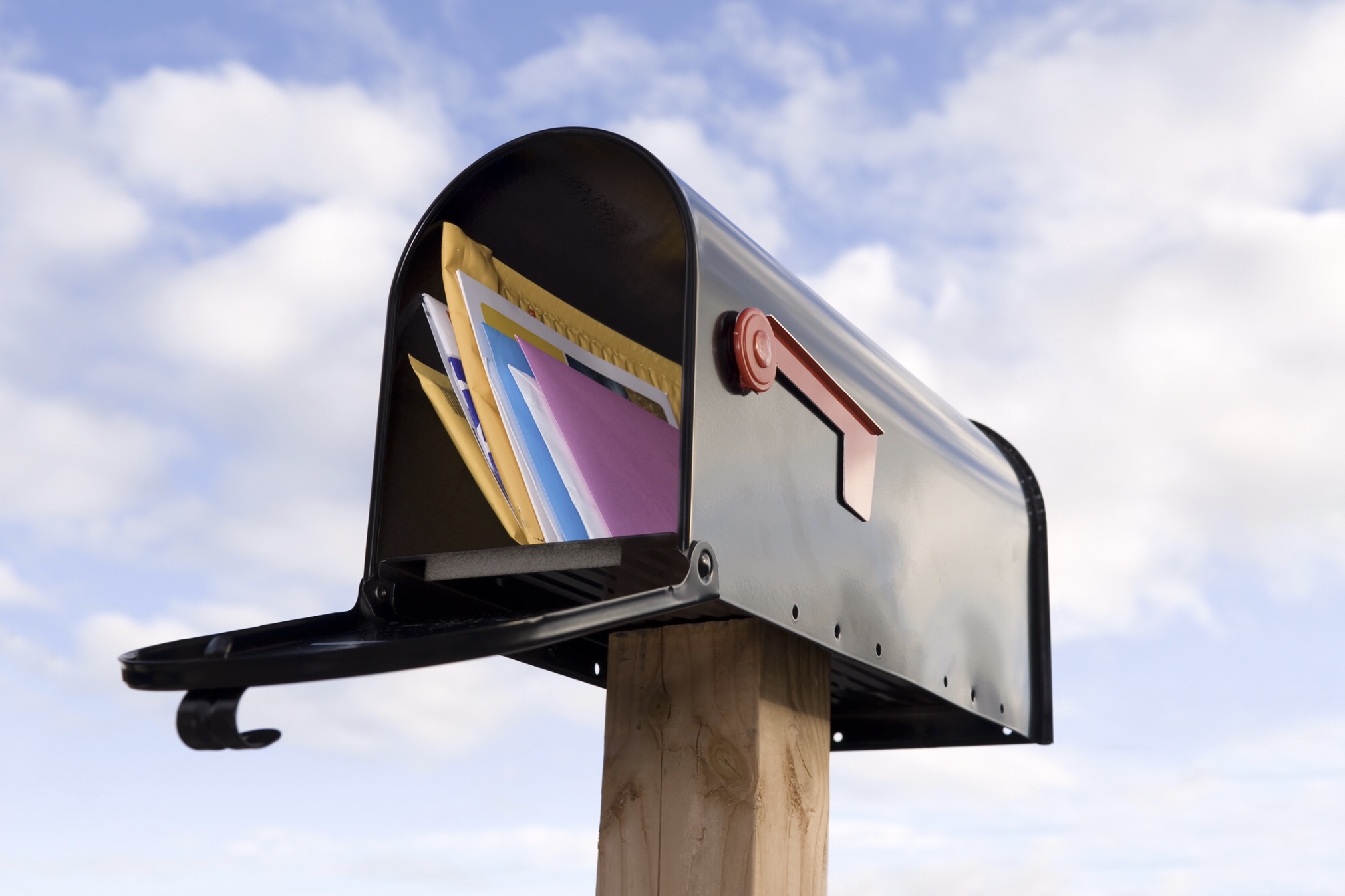 Mailbox full of mail and postcards